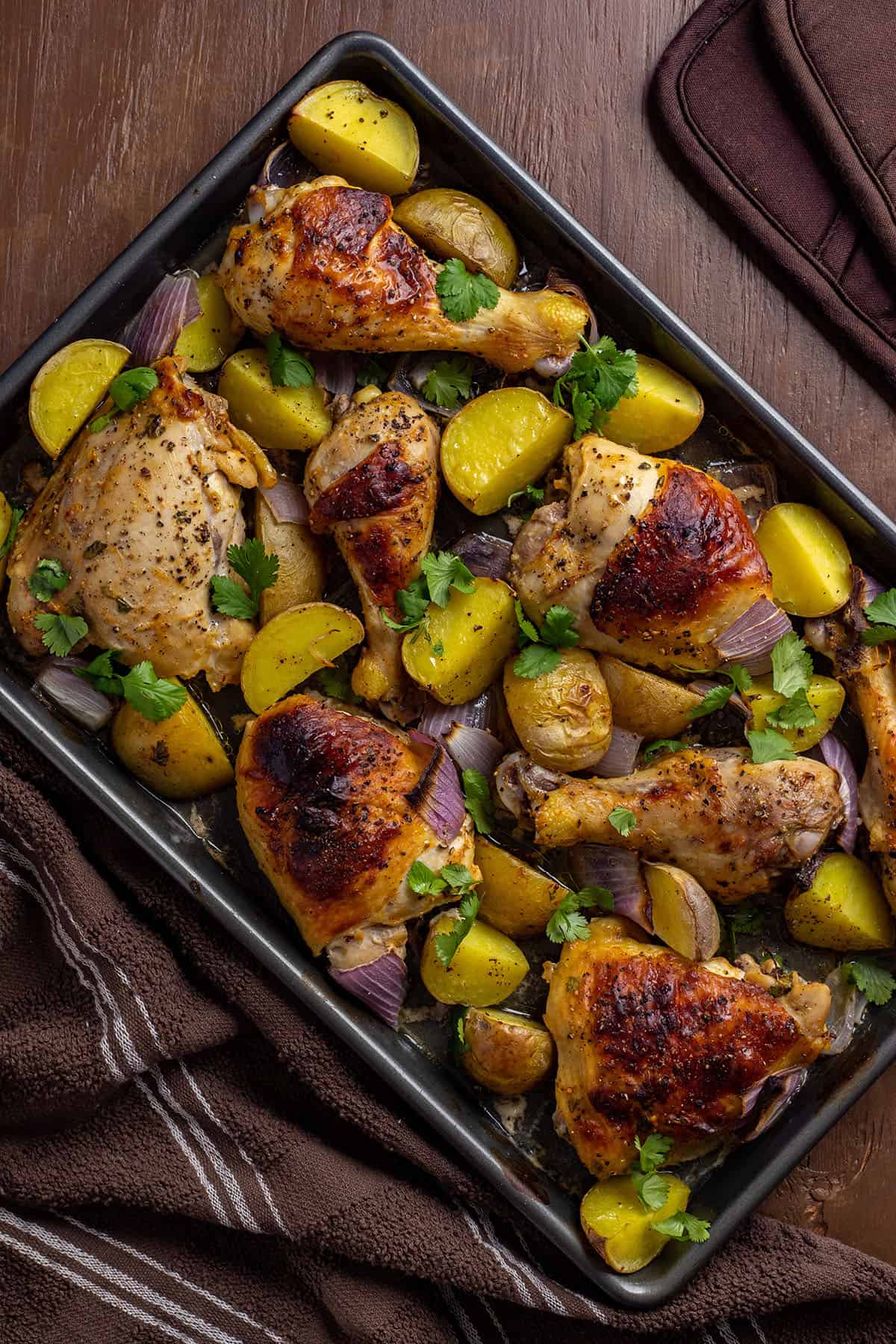 baked chicken and potatoes on sheet pan