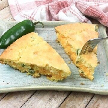 two slices of baked cornbread with fork in one slice