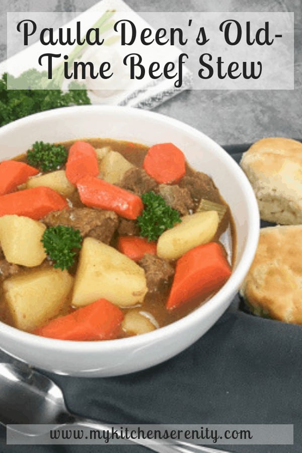 beef stew in white bowl with biscuits on the side