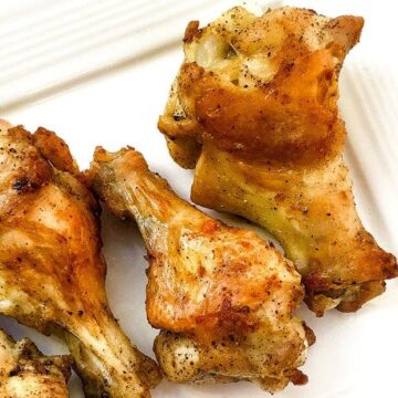 baked lemon pepper wings on white plate