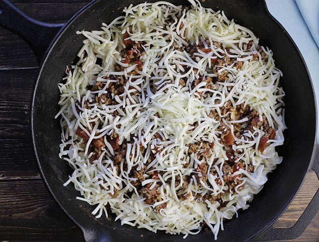 cheese layer on top of tomato meat sauce and cheesy noodles for beef noodle casserole