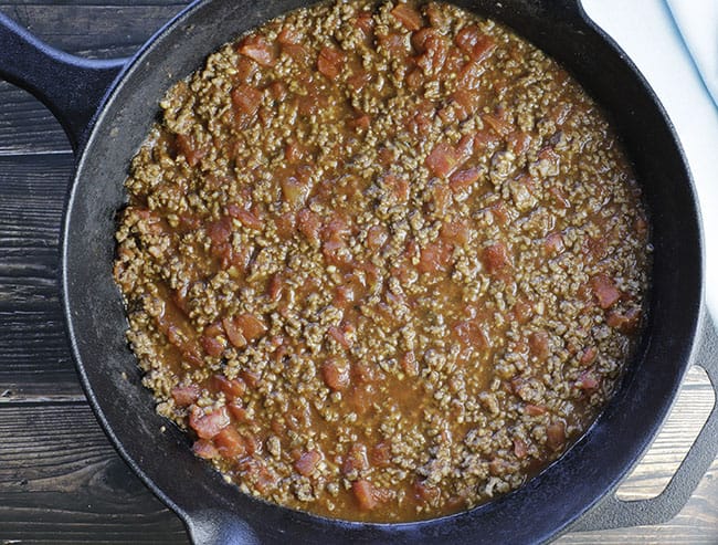 cooked tomato meat sauce in cast iron skillet