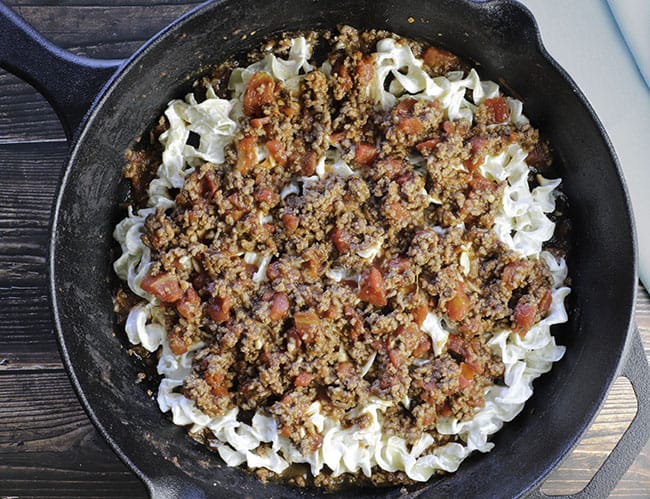 meat sauce layered on top of cheesy noodles for beef pasta bake