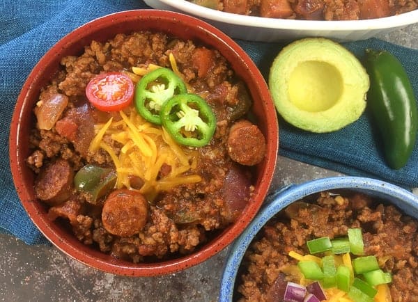 cooked chili in red and blue bowls