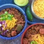 cooked chili in colorful bowls