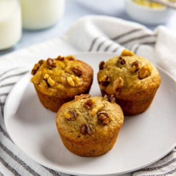 baked muffins stacked in teal blue bowl