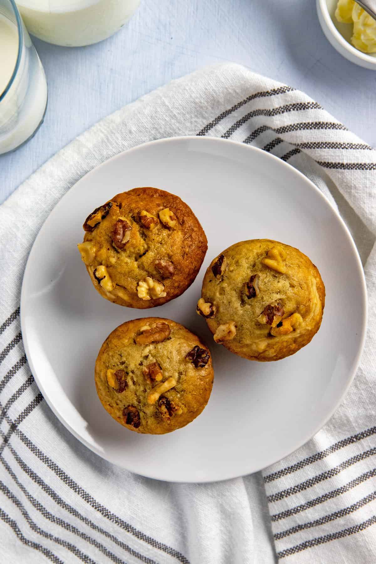 three baked muffins on white plate