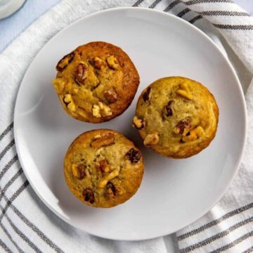 three baked muffins on white plate