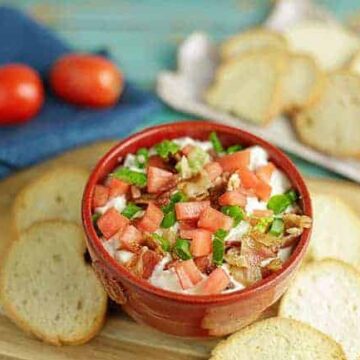 BLT Dip in red bowl with Crostini slices on the side