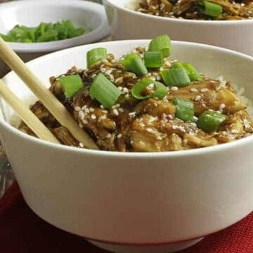 easy honey garlic chicken with sticky sauce in white bowl with chop sticks