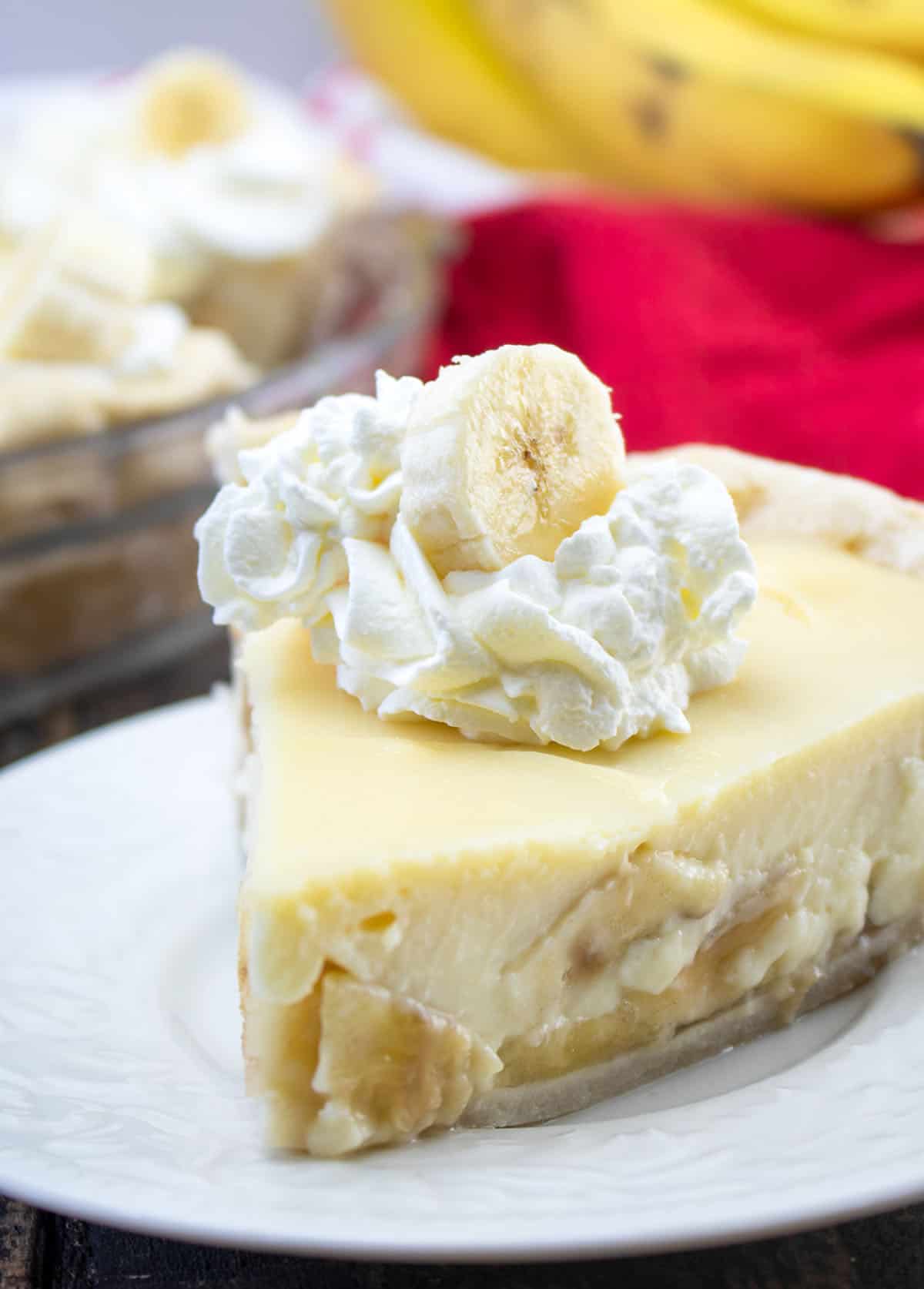 slice of pie with whipped cream and banana slice on top