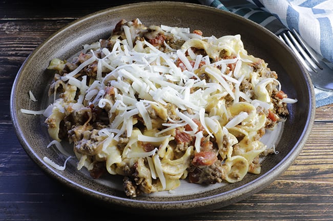 baked ground beef noodle casserole on tan plate