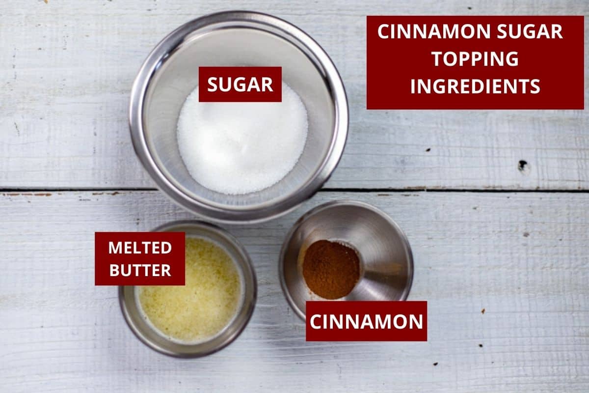 melted butter, cinnamon, and sugar measured out in bowl on counter