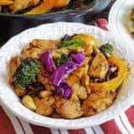 cashew chicken and cabbage stir fry on white plate
