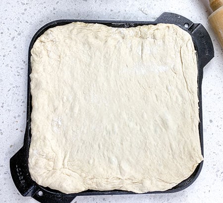dough rolled out and placed on skillet