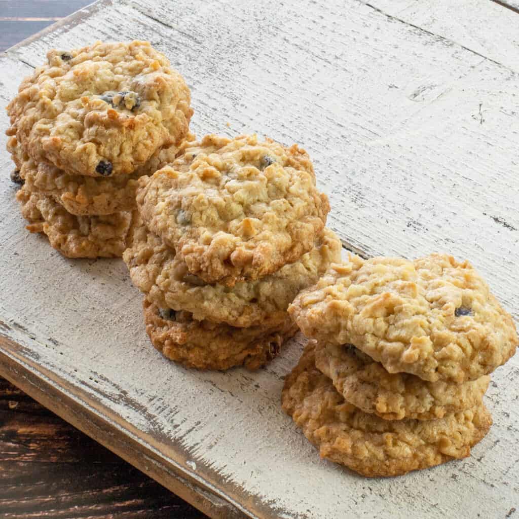 three stacks of baked cookies on white wooden board