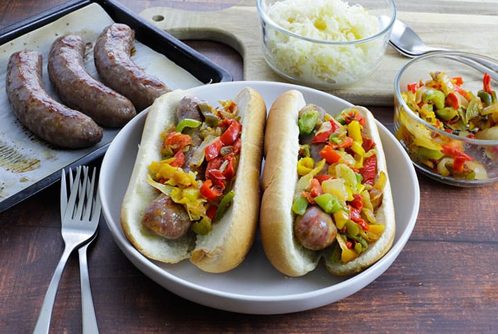 brats in bun with bell peppers and onions