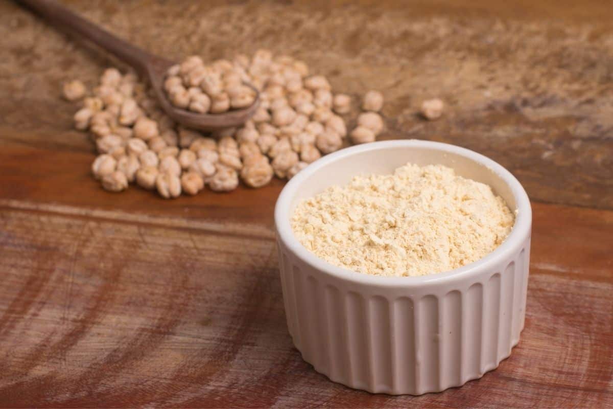 chickpea flour in bowl next to whole chickpeas