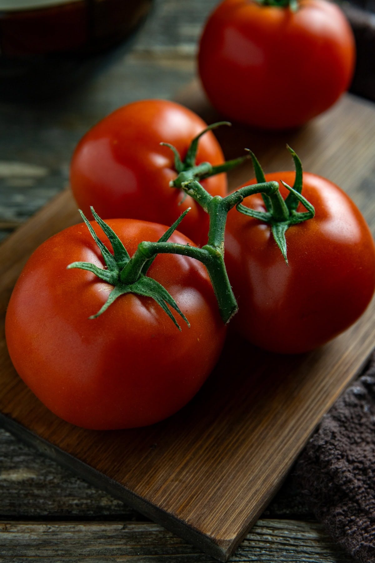 A cluster of fresh tomatoes on the vine.