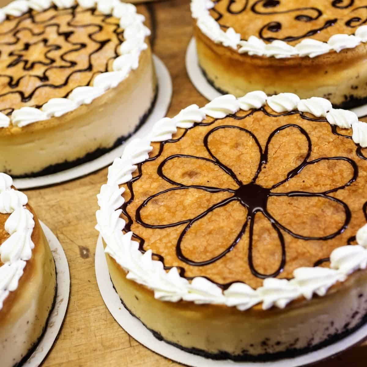 cheesecake decoration ideas cheesecake with swirl of chocolate syrup in shape of a flower with whipped cream around edges