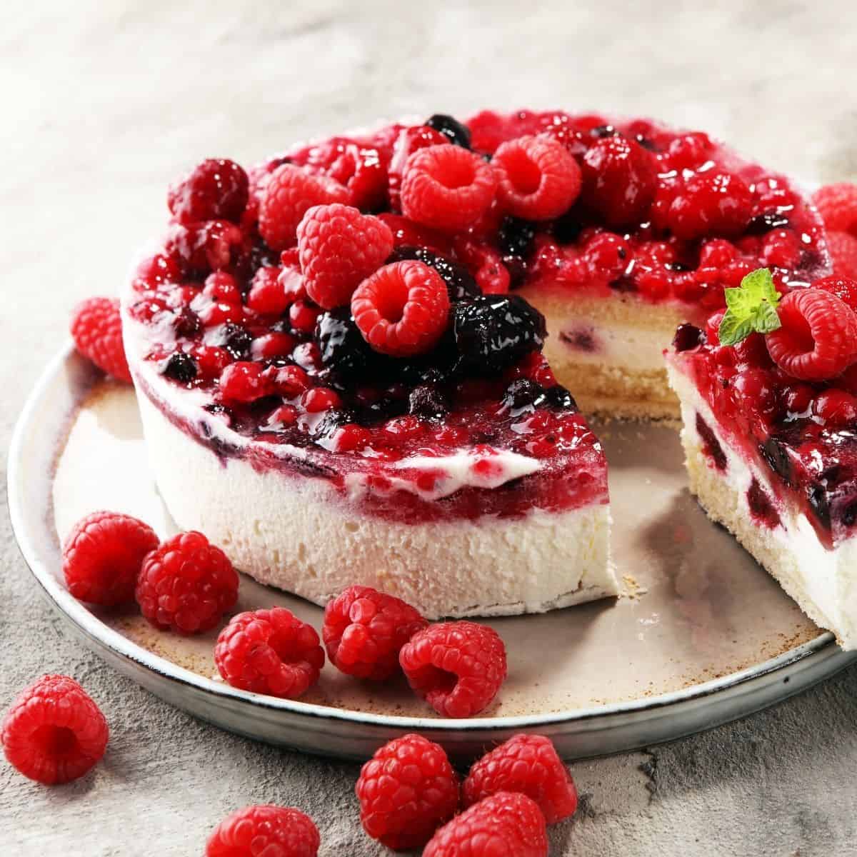 whole cheesecake topped with blueberries and raspberries