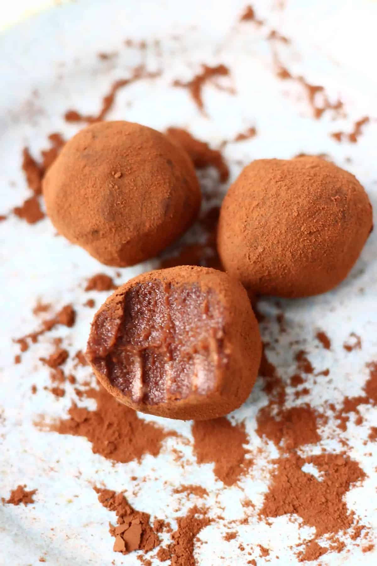 3 cocoa dusted truffles on white plate