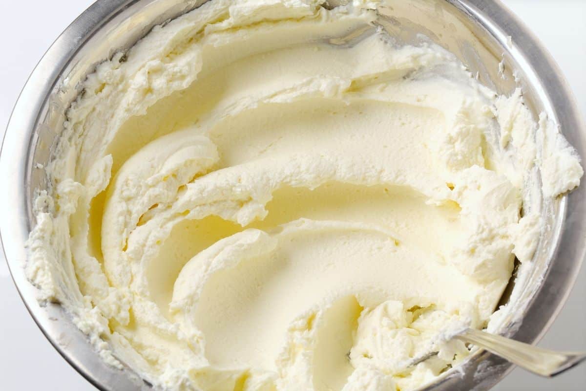 cream cheese that has been stirred in glass bowl