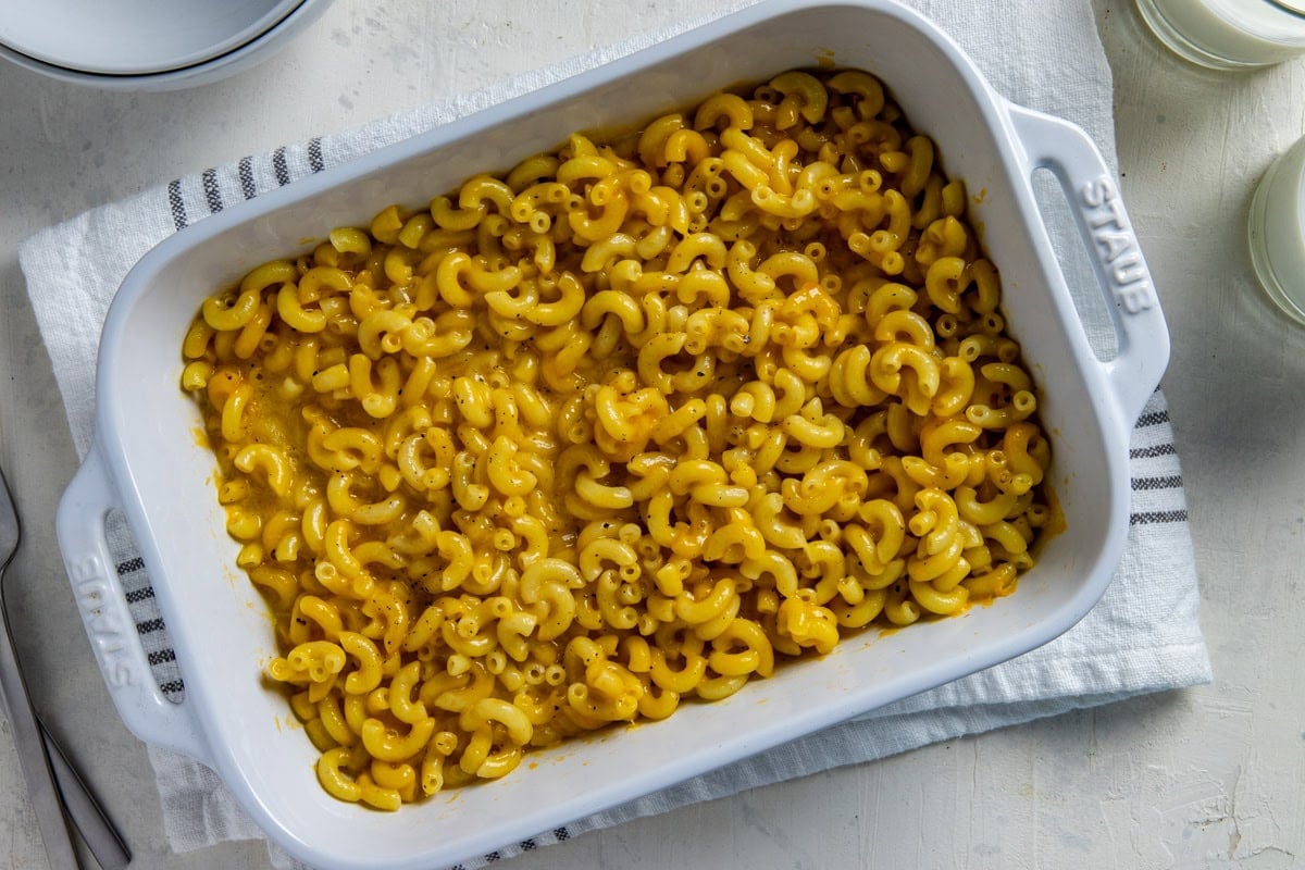 Baked mac and cheese in a white casserole dish.