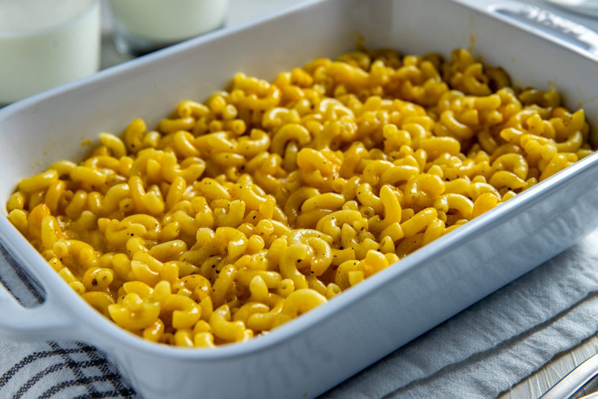 Baked mac and cheese in a white casserole dish.