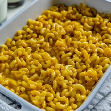 Baked mac and cheese in a white casserole dish.