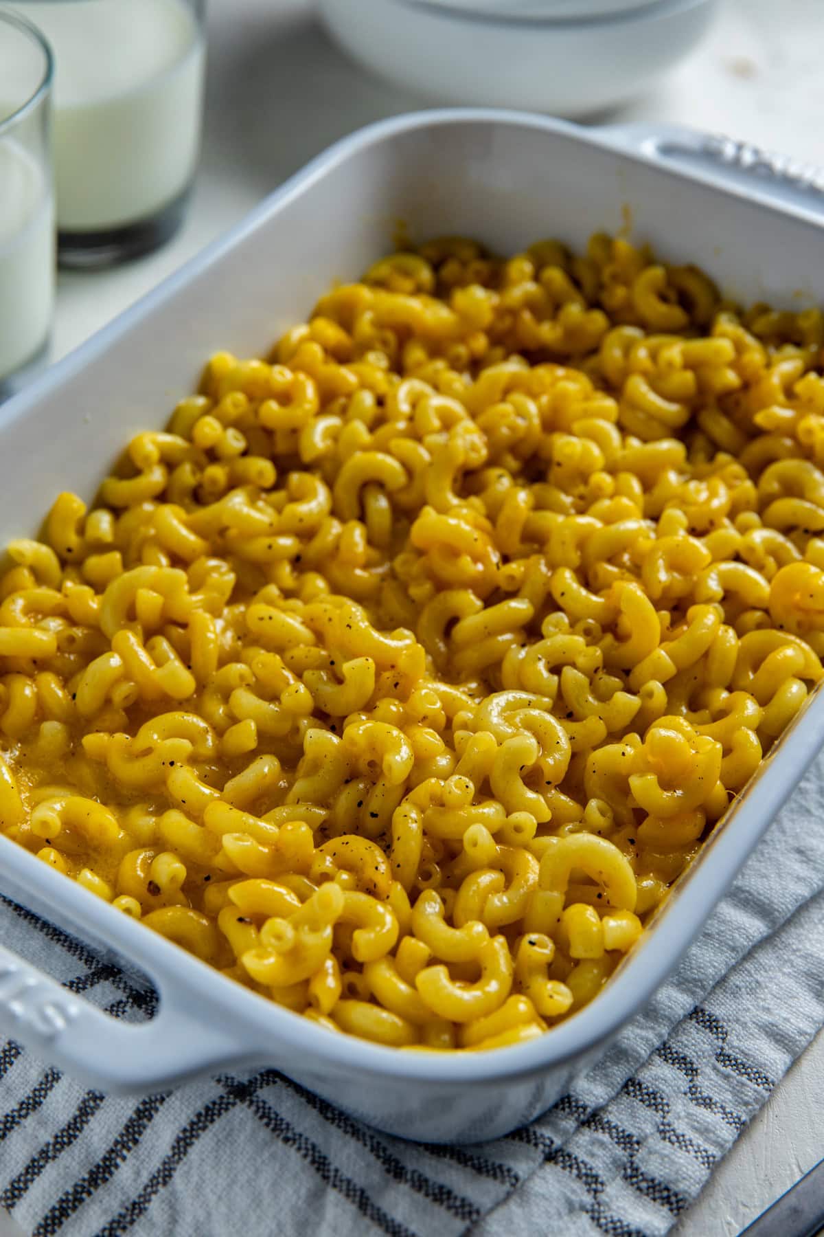 Baked mac and cheese in a white casserole dish.