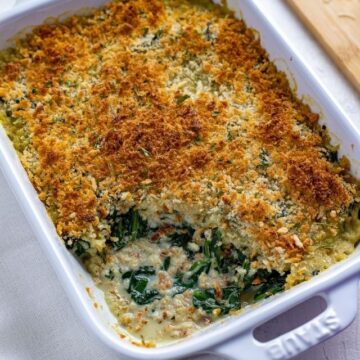 picture of spinach parmesan casserole in white baking dish