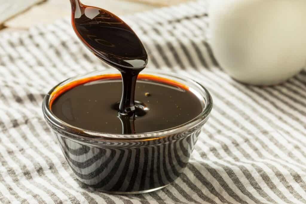 picture of glass container of molasses