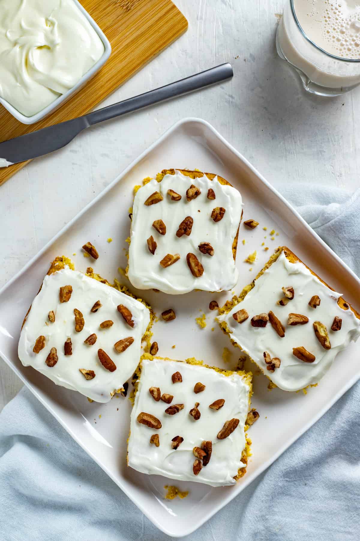 baked and frosted squares on square white serving platter