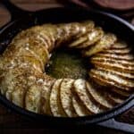 baked sliced potatoes in cast iron skillet