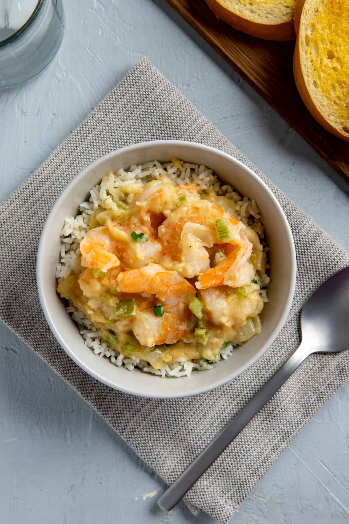 cooked shrimp stew over rice in white bowl
