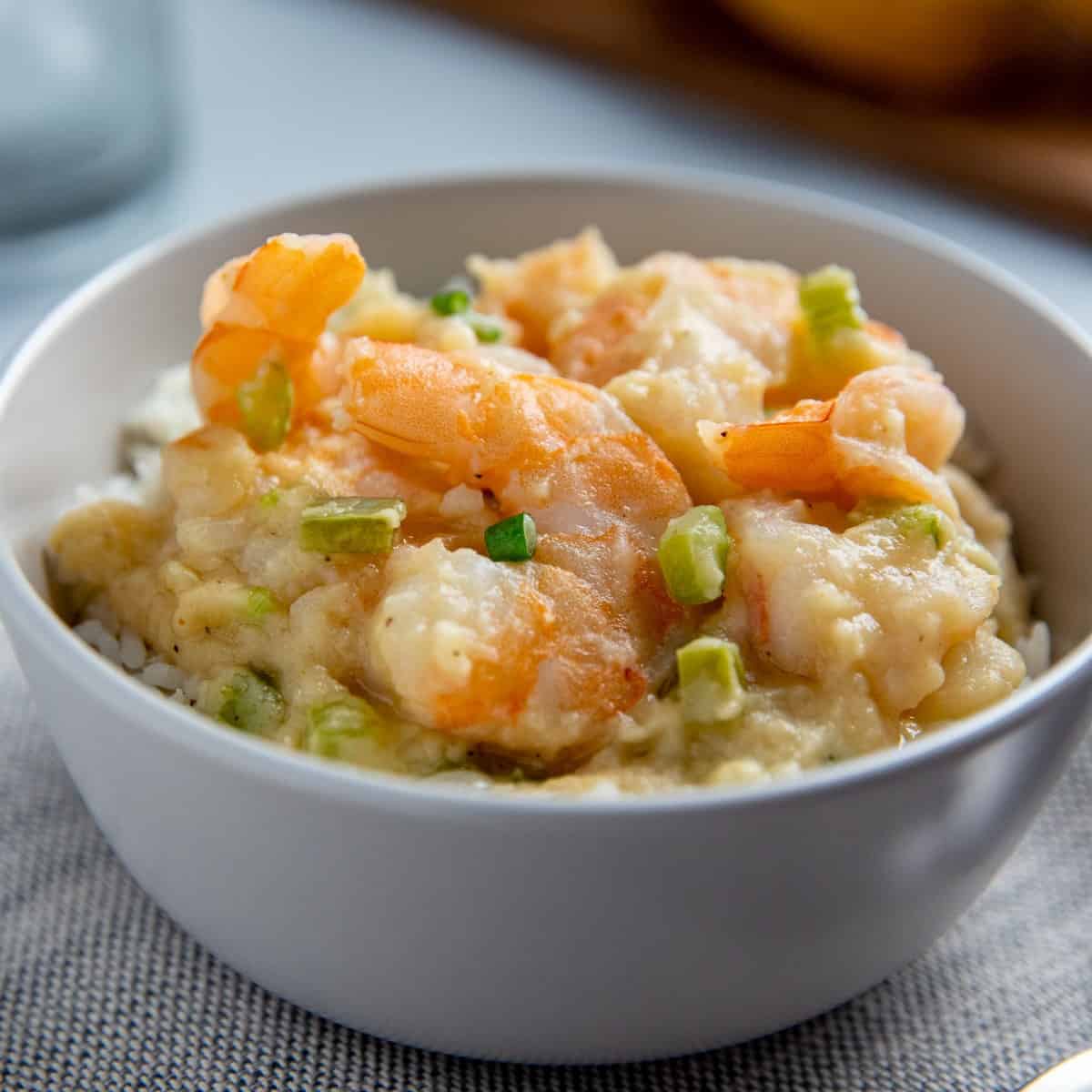 cooked shrimp stew over rice in white bowl