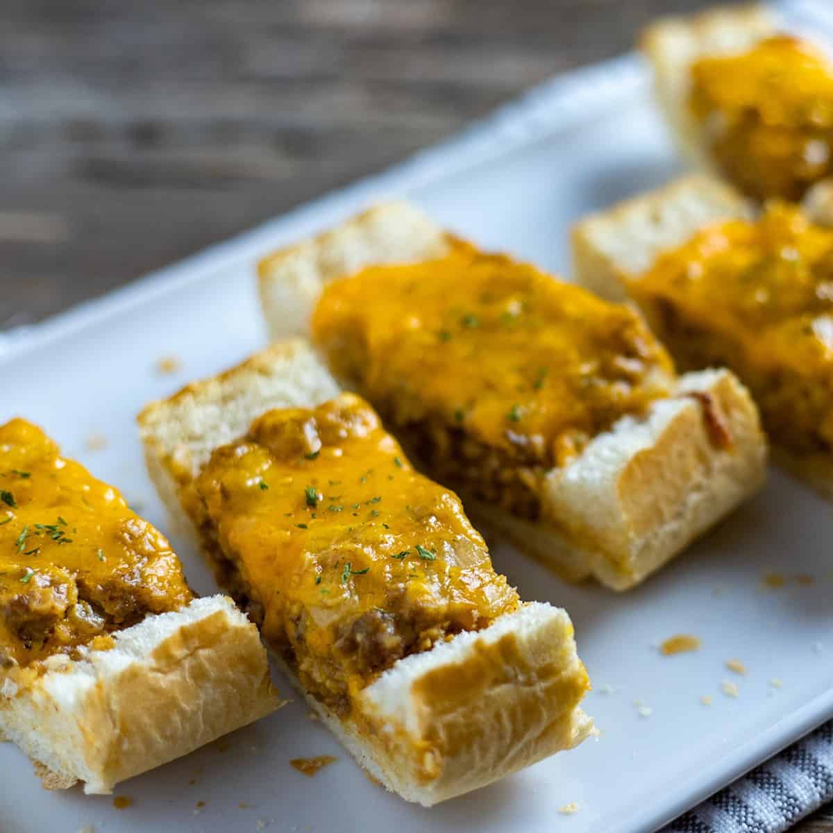 baked and sliced stuffed bread on white serving tray