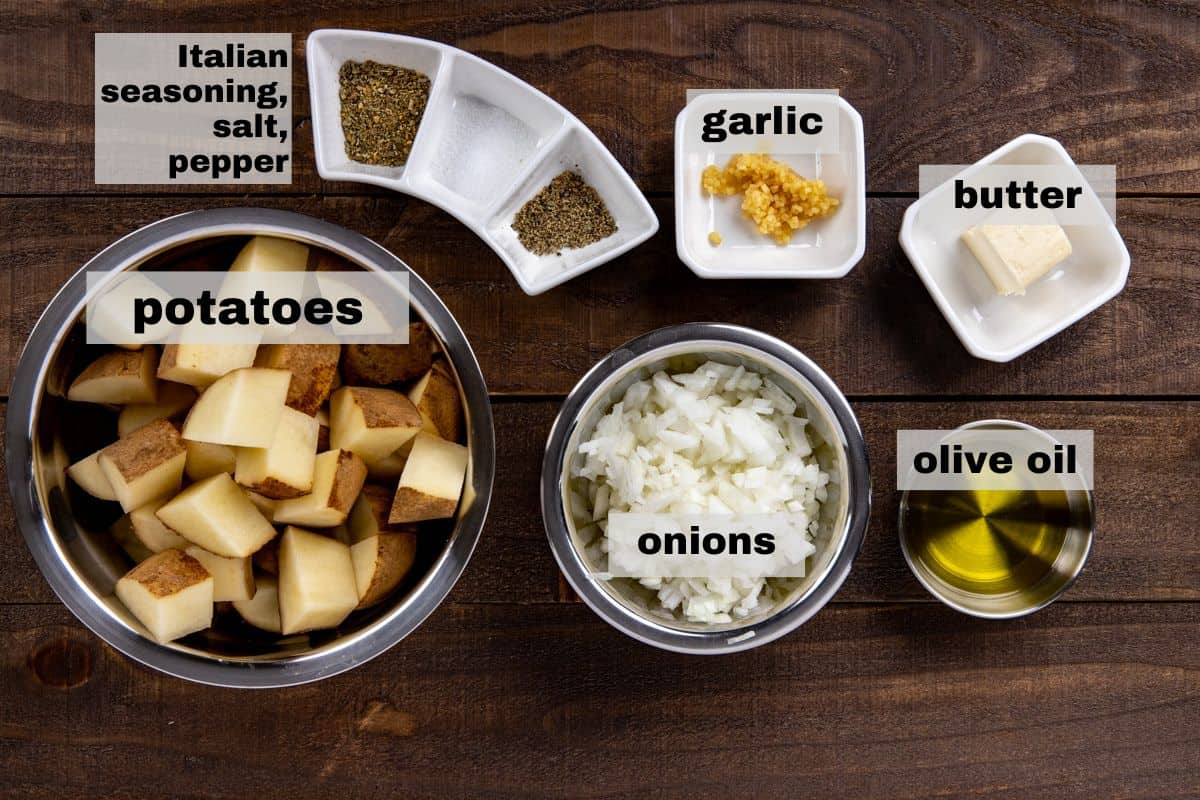 fried potatoes and onions ingredients. Measured out in individual containers on wooden counter top.