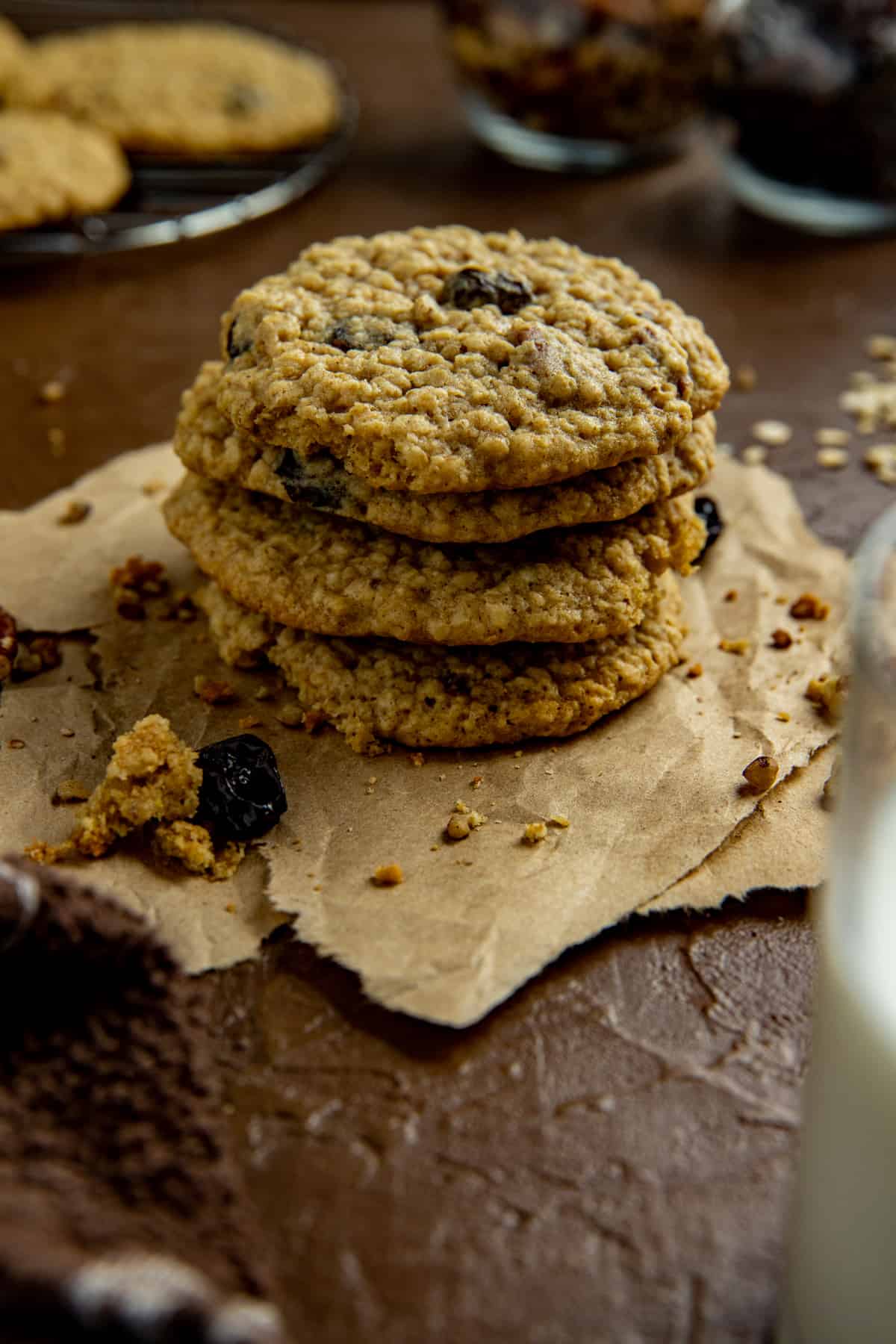baked cookies stacked on top of each other on brown parchment paper.