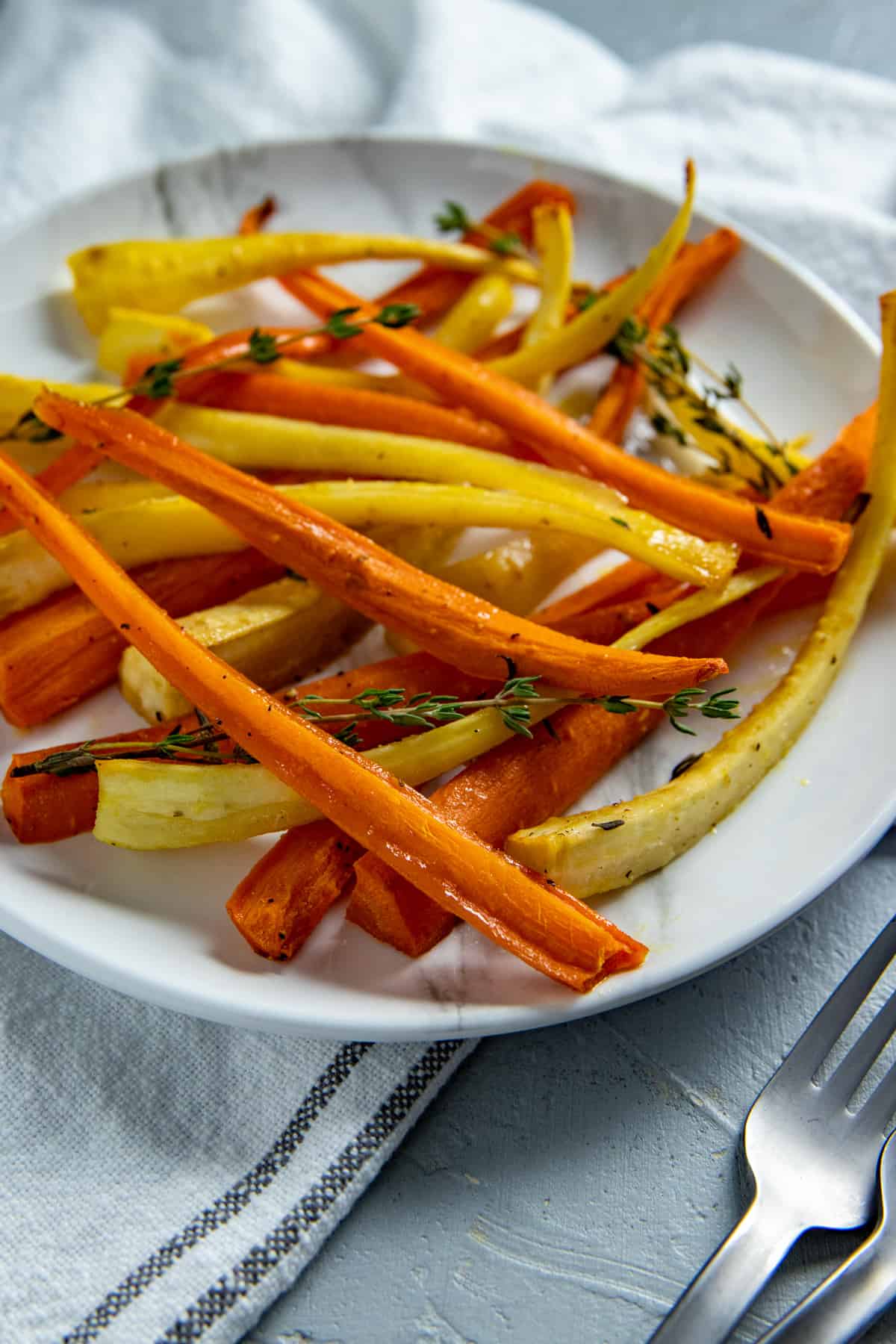 Roasted Carrots and Parsnips on white serving plate.