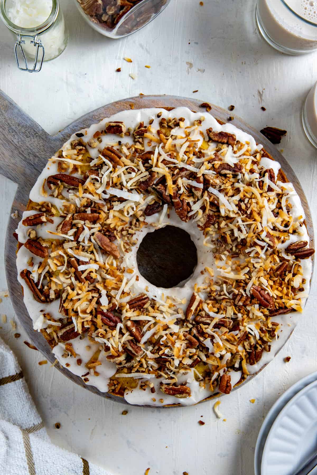 Coconut Coffee Cake on round wooden cake platter.