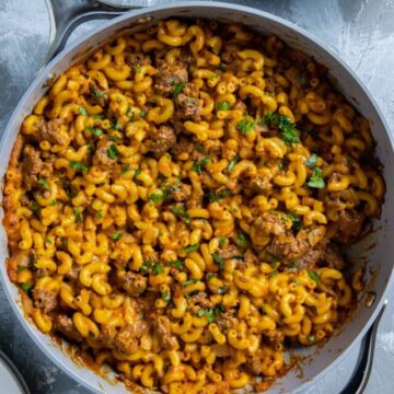 Cooked hamburger mac and cheese in skillet.