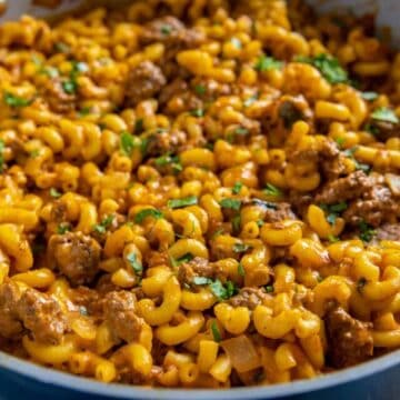 Cooked hamburger mac and cheese in skillet.