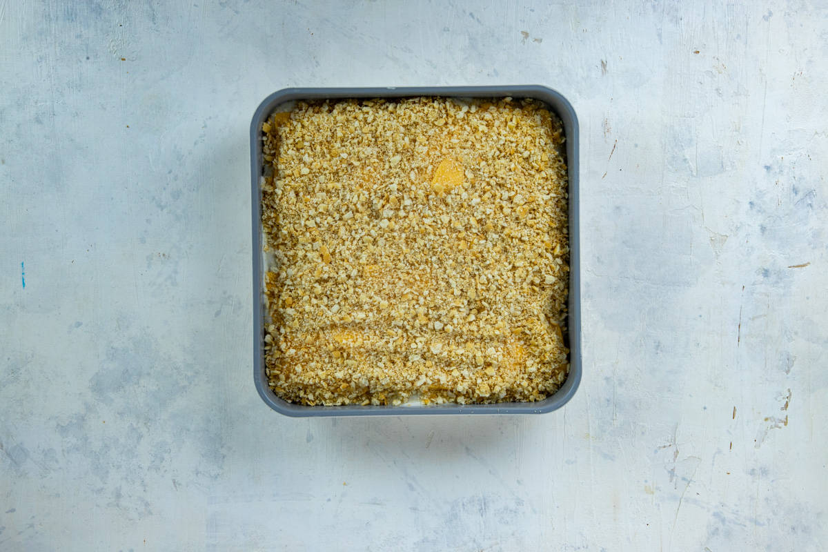  A layer of crushed Ritz crackers on top of the Velveeta cheese layer.