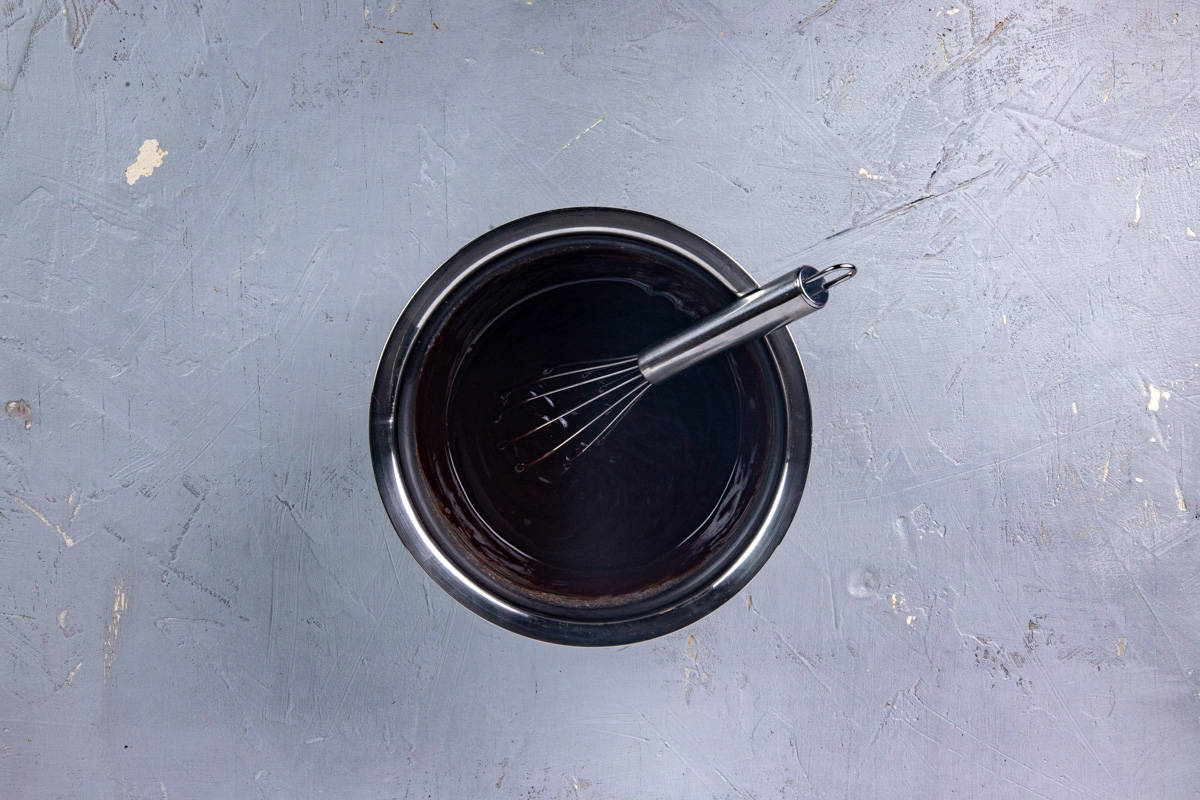 Ganache in small pan with whisk in the pan.