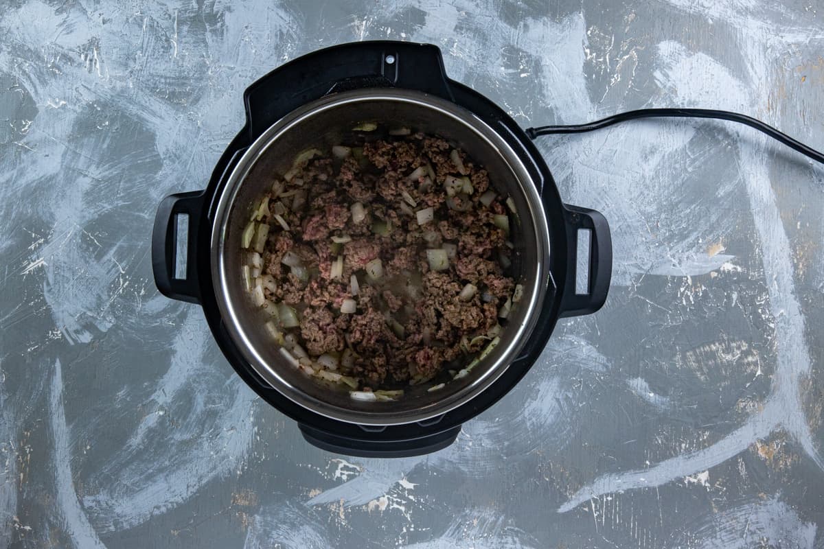 Cooked chopped onion and ground beef in the Instant Pot.