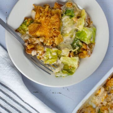 Cabbage casserole in a white plate with a fork on the side.