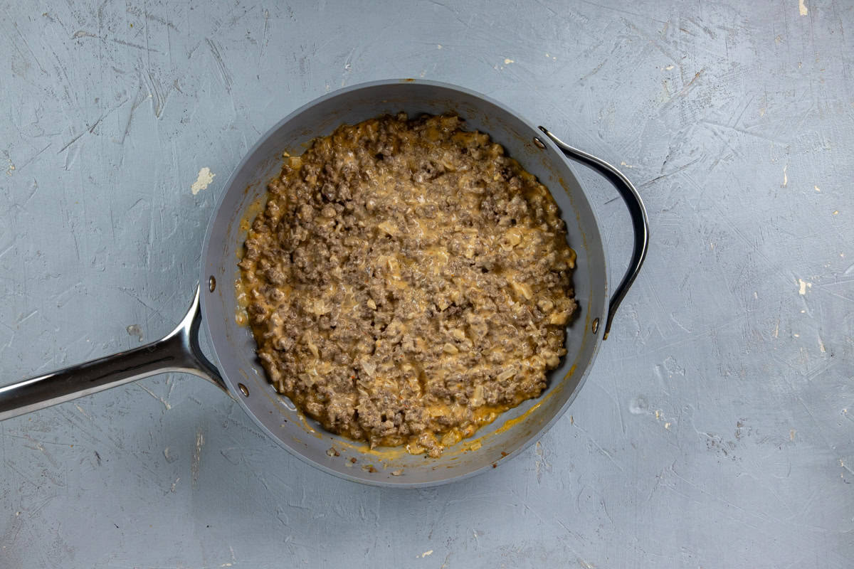 Cooked ground beef with Thousand Island Dressing mixed up in a skillet.
