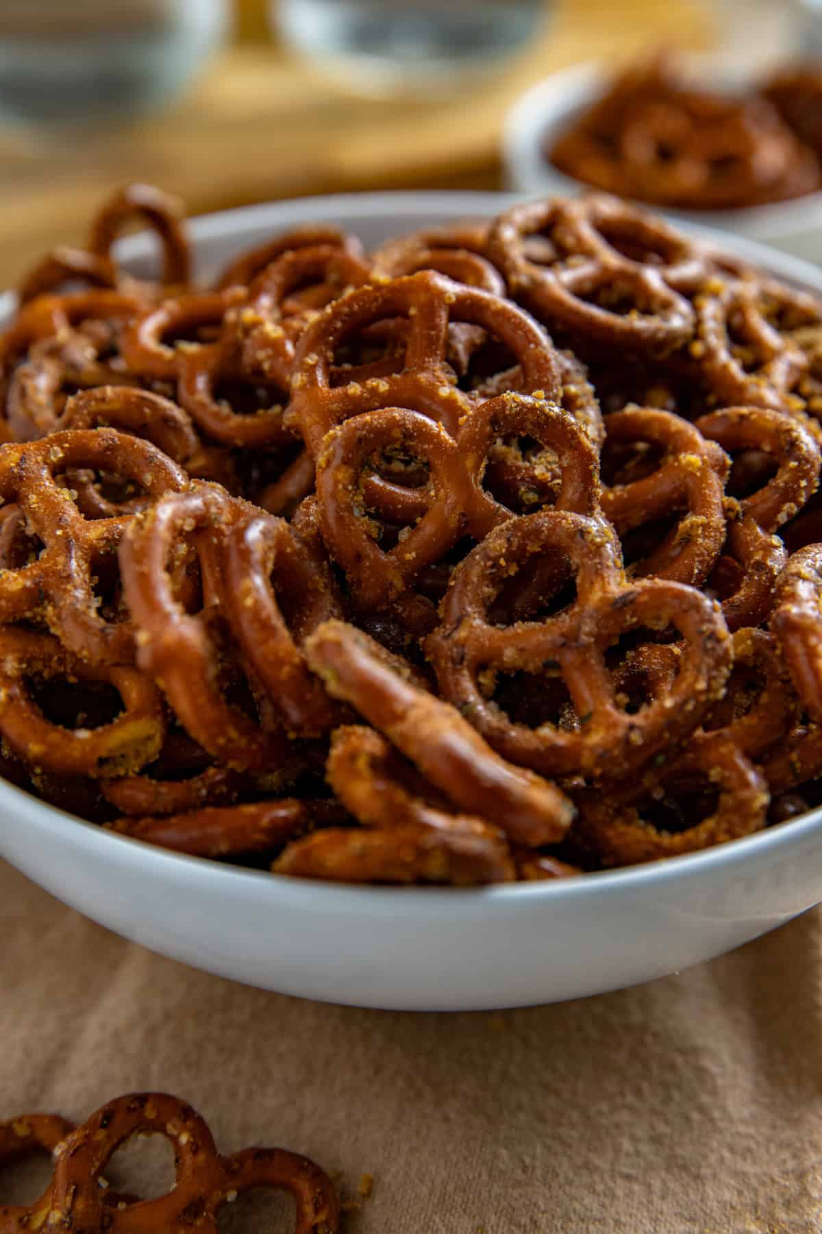 Seasoned pretzels in a white serving bowl.